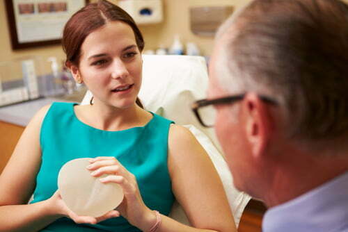 Woman-holding-implant