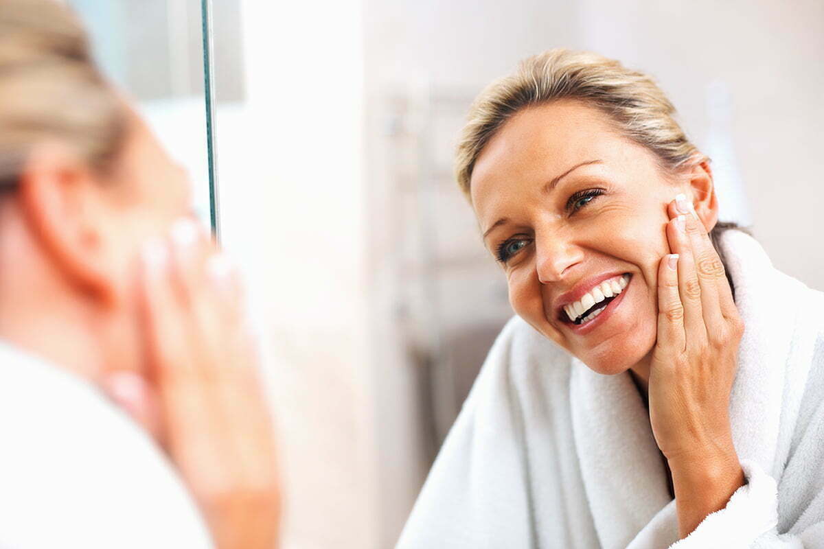 woman looking in mirror