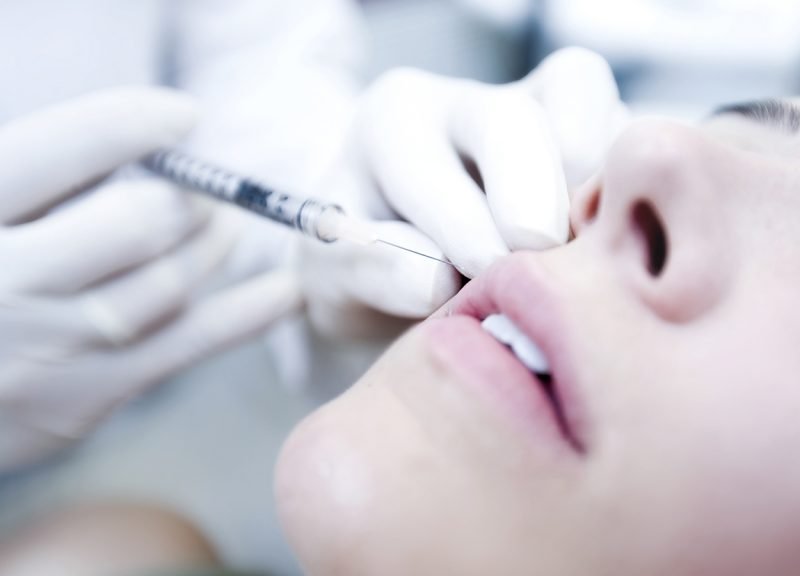 Woman getting nanofat grafting facial fat injection treatment